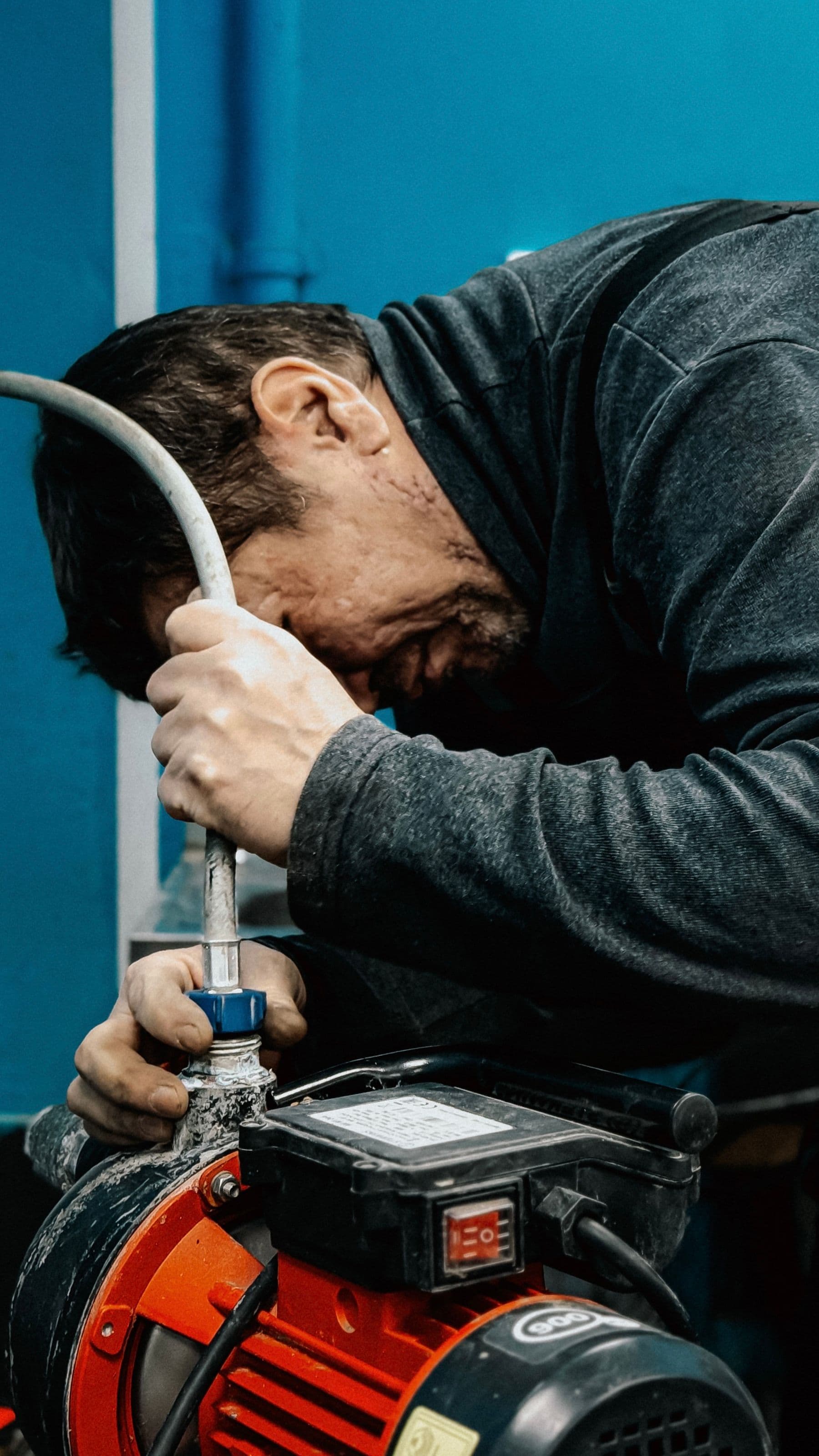 Technician adjusting a pump on site